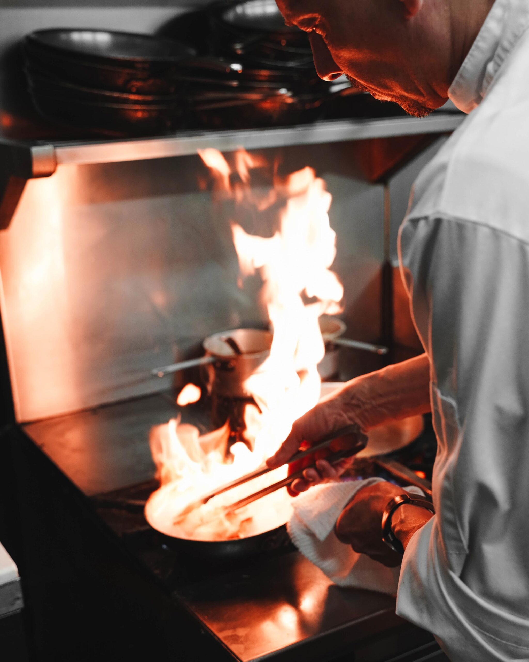 Chef cooking flambé style.