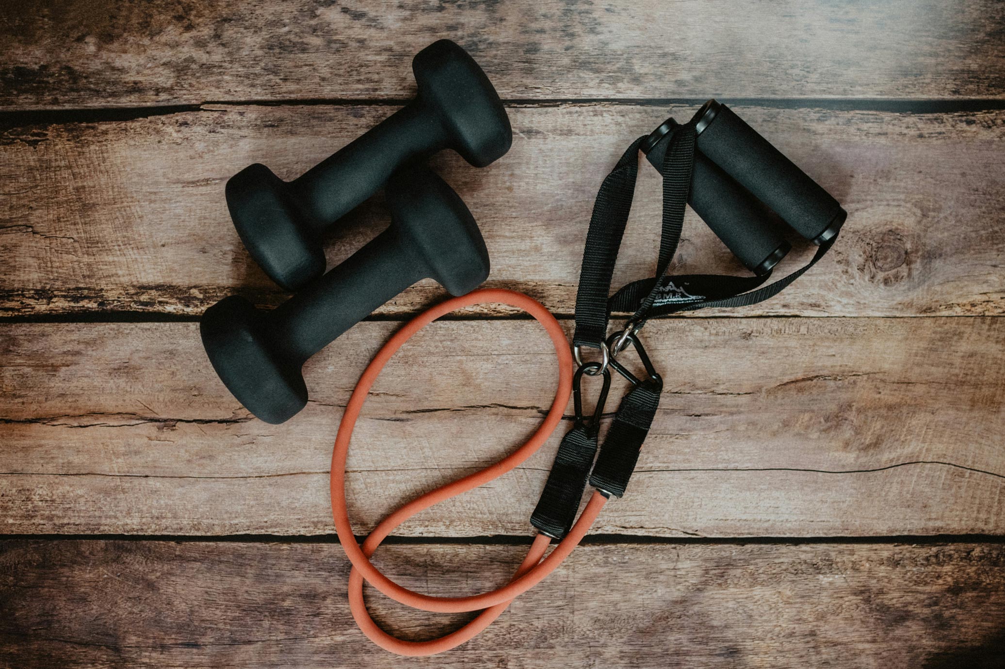 Gym equipment from above on a wooden floor.
