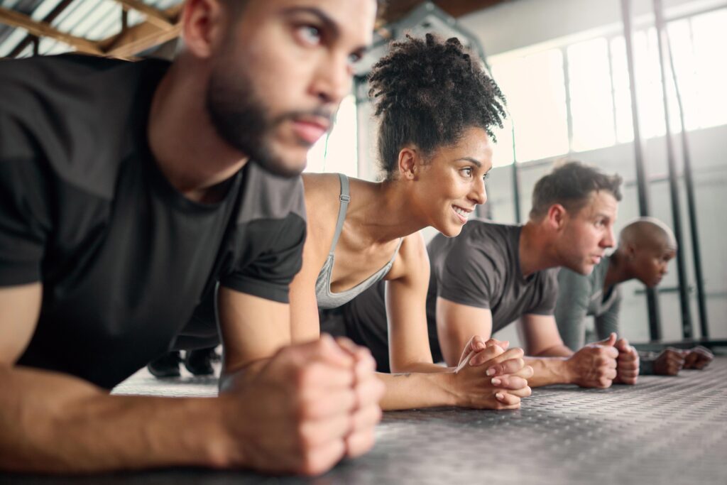Group of people doing a plank at a fitness class.