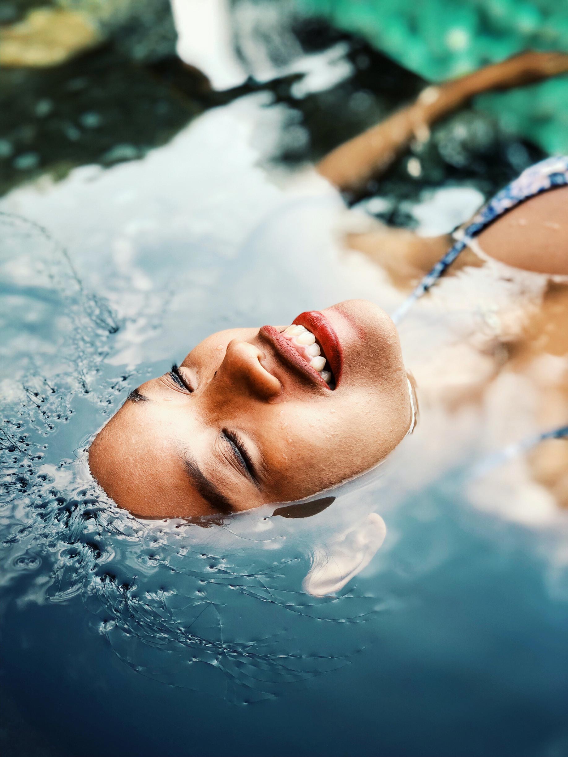 women lying face up in spa pond